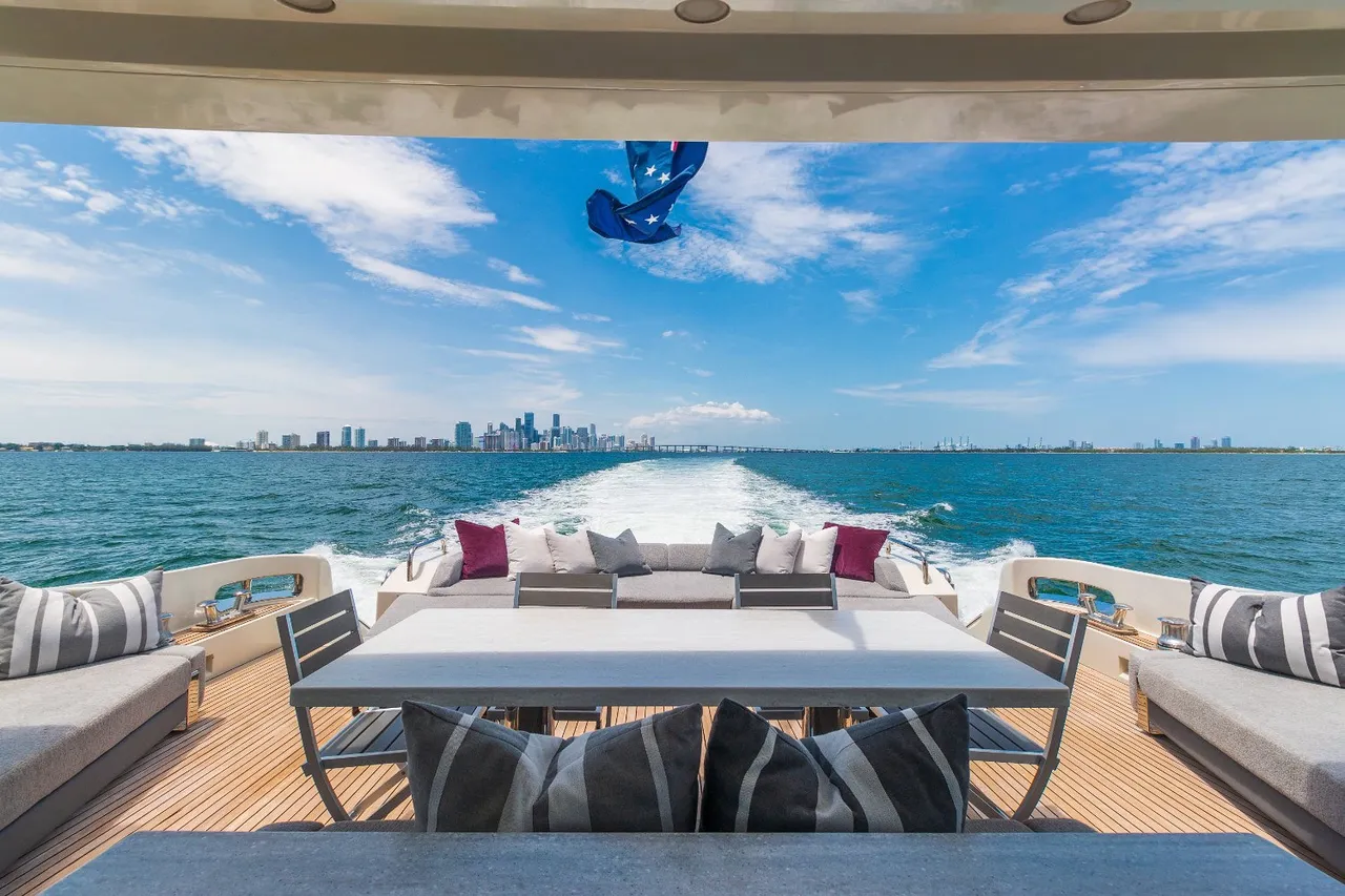 Side aerial view of the yacht with all features deployed,
  including slide, pool, and jet ski